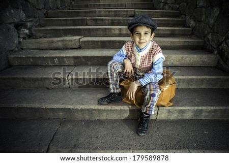 Exterior stairs and child with vintage bag. Vintage clothes style