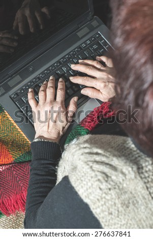Old women using old laptop