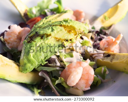 Fresh green salad with shrimps and avocado