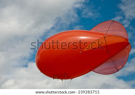 Red weather balloon on a blue sky