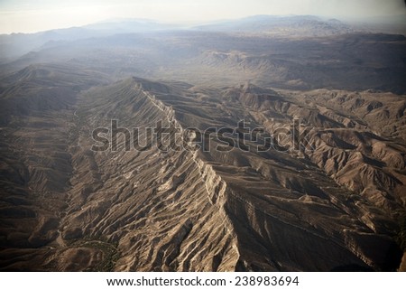 The in flight view of the mountain at east of mesa. Covered by the slight mist, draws it to the beautiful landscape.
