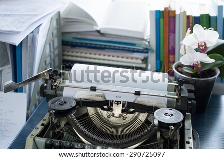 Vintage typewriter on a table with books