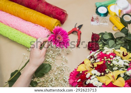 Florist at work. Woman making bouquet of flowers