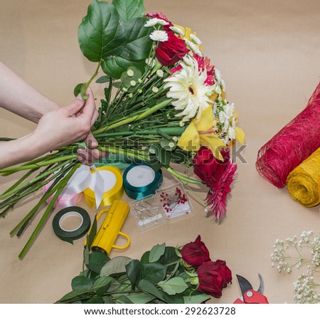 Florist at work. Woman making bouquet of flowers