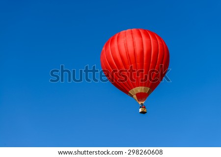 Red hot air balloon in blue sky