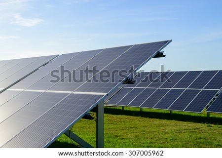 Solar panel produces green, environmentally friendly energy from the sun with blue sky