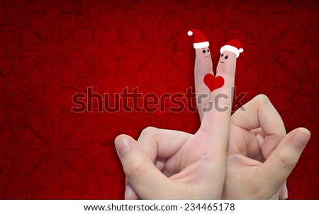 Concept or conceptual old vintage red pattern paper background with man and woman finger in love with Christmas hats and a heart painted, metaphor to family, couple, celebration, holiday, roamnce card