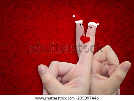 Concept or conceptual old vintage red pattern paper background with man and woman finger in love with Christmas hats and a heart painted, metaphor to family, couple, celebration, holiday, roamnce card
