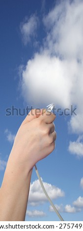 Conceptual human or man hand holding a internet or data cable in clouds over the blue sky background