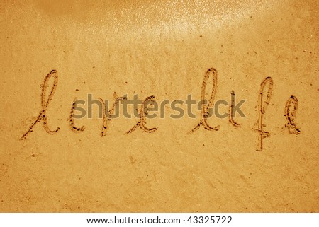 Live life handwritten in sand for natural, symbol,tourism or conceptual designs