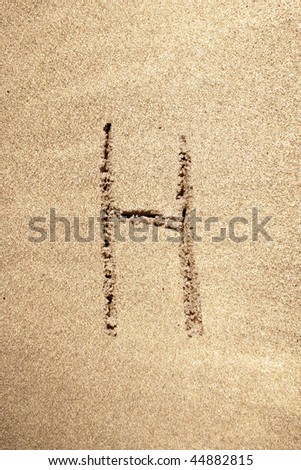 Conceptual abstract font in sand on exotic beach sea shore handwritten in sandy texture background in summer for alphabet,education,letter,text,vacation,nature,alphabetical,vintage or tourism concept