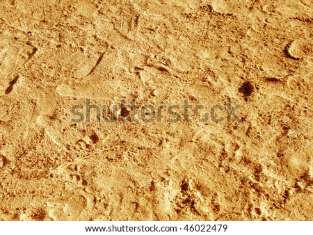 Golden sand background with human foot prints