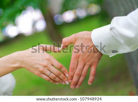 wedding couple showing shape of heart from their hands. single whole from man and woman.
