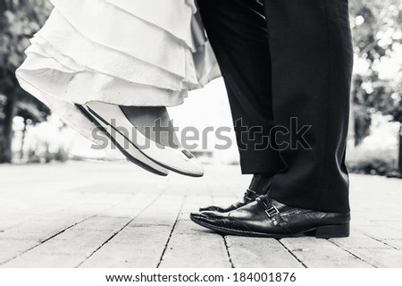 wedding shoes in a standing bride and groom. retro vintage photo