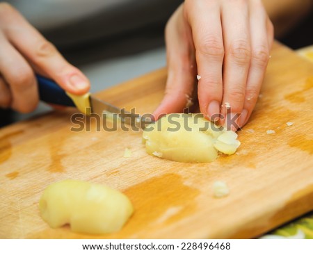 food preparation. cutting potato for vegetarian table