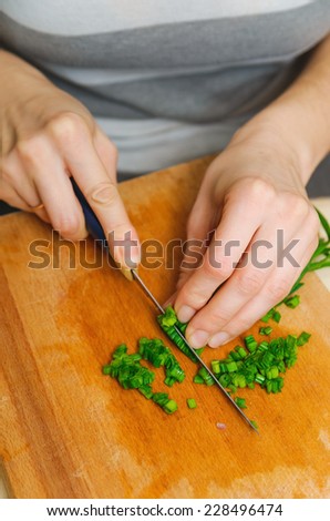 food preparation. cutting green onion for vegetarian table