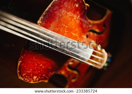 fretboard with string of old shabby cello. Selective soft focus on string and sounding board