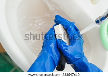 washing clothes of white soap in rubber gloves