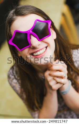 face of cheerful smile positive young woman in stars glasses