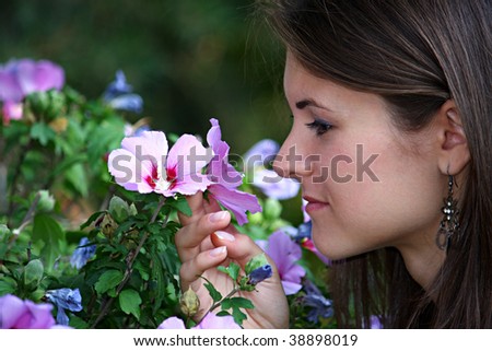 Pretty girl smelling a flower
