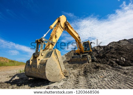 Excavator bucket on clay mining site. Wide angle