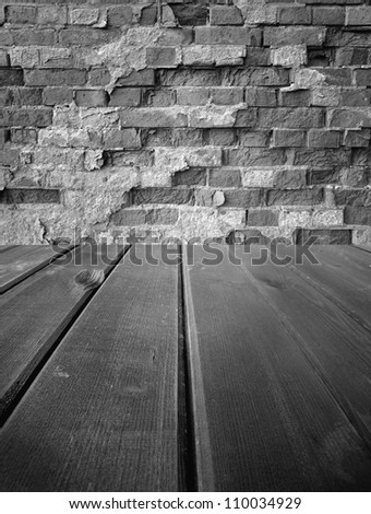 Old wooden  dark stage and an old brick wall, background
