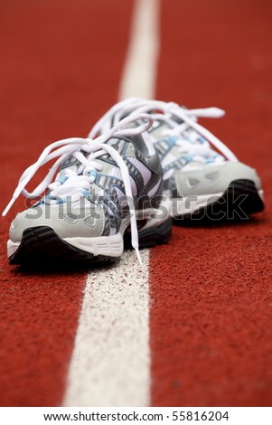 Sports shoes for tennis on court background