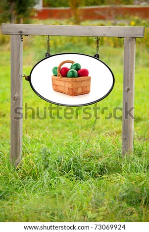 Easter  colorful eggs in wicker basket on rural billboard