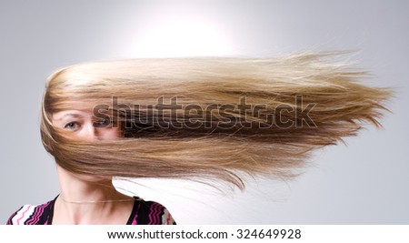Strong wind blows on woman\'s hair