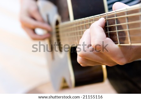 Young artist playing guitar on white background