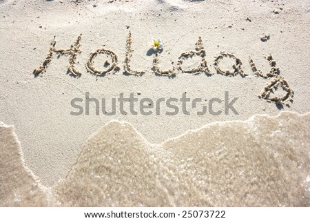 Holiday inscription on the sand beach