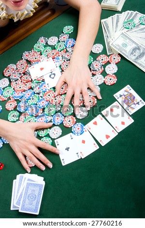 Female hands grabbing the bank in poker game