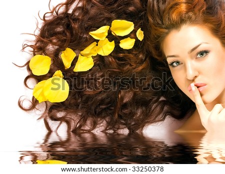Close-up beautiful red-haired lady with yellow petals in her hair