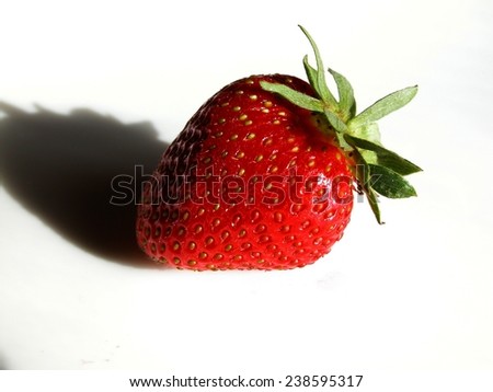 Picture of strawberry with shadow on white background.