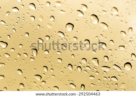 Drop water on glass with gold light