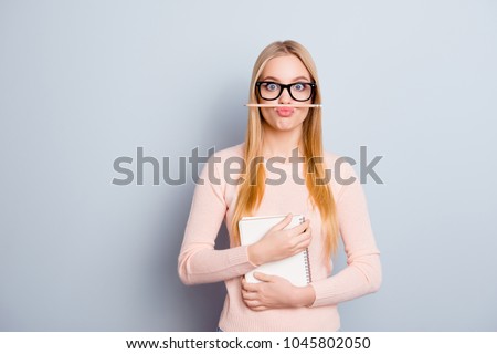 Teen age idea draw dreamy mad surprised wondered blonde long hair people concept. Portrait of cute sweet lovely pretty funny funky assistant trainee holding pencil with lips isolated gray background