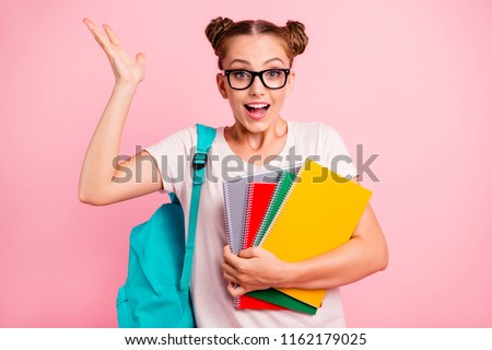 Can you imagine? Classes with a tutor were incredibly easy! Young reader girl lifts her palm up holding colored notebooks and smiling isolated on vivid pink background