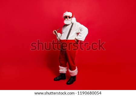 Full length body size of nice calm peaceful Santa pulling suspender preparing to feast festive party promo sale discount isolated over red background