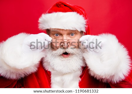 Holly jolly x mas noel coming! December sale discount concept. Mature stylish impressed incredible Santa in costume look at camera with open mouth staring eyes isolated on shine red background