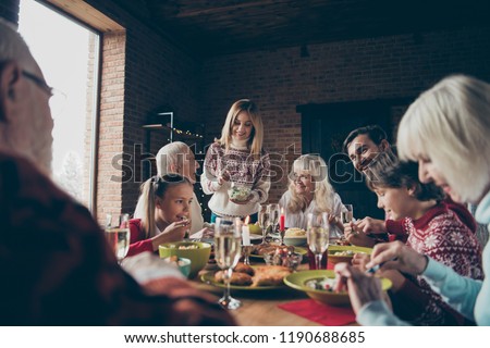 Noel evening, night family gathering, meeting. Cheerful grey-haired grandparents, grandchildren, brother, sister, relatives sitting at table, house fun joy party, feast, eating tasty yummy food