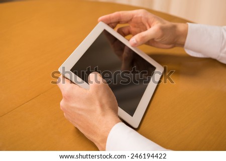 Working in digital age. Close-up of man holding a digital tablet.