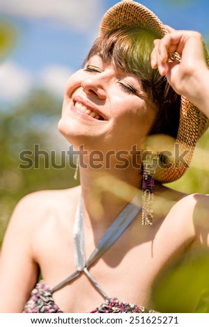 cute girl in a hat closed her eyes and lifted her face to the sun
