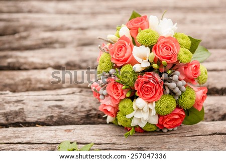 closeup image of stylish bridal bouquet on the green grass. bridal bouquet of flowers from the bark of Sola, cotton and brunei