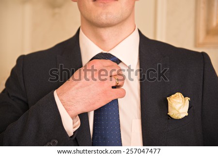 Cropped image of man in suit. A man wearing a jacket with a boutonniere