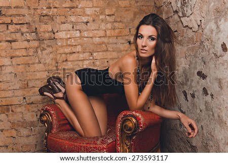 sexy girl posing on the red chair