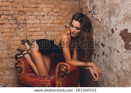sexy girl posing on the red chair