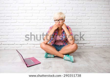 young woman thinking of solving the problem and  sitting on the