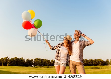 couple in love walking with balloons