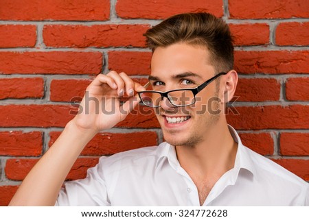 subtle handsome man holding his glasses