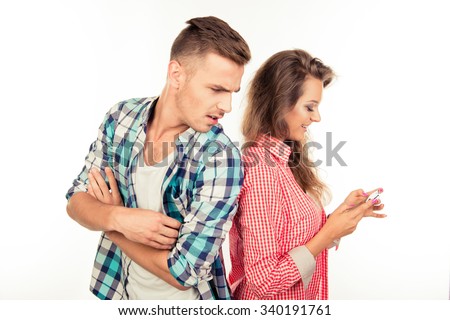 Cheerful woman typing message ignoring her boyfriend